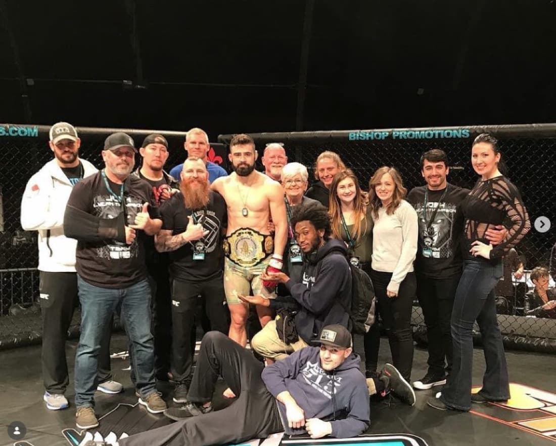 Team 515 fighter with championship belt
